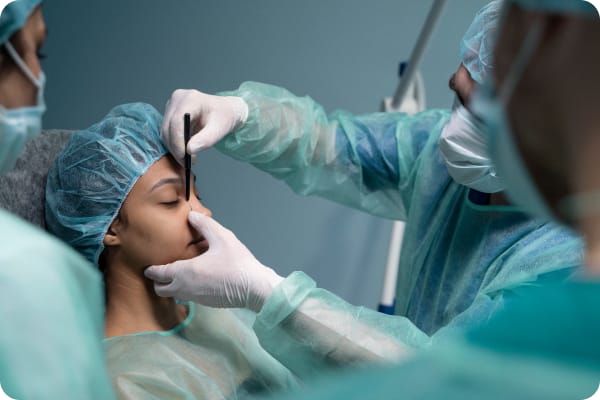 A team of professionals performing a Oral and Maxillofacial Surgery.