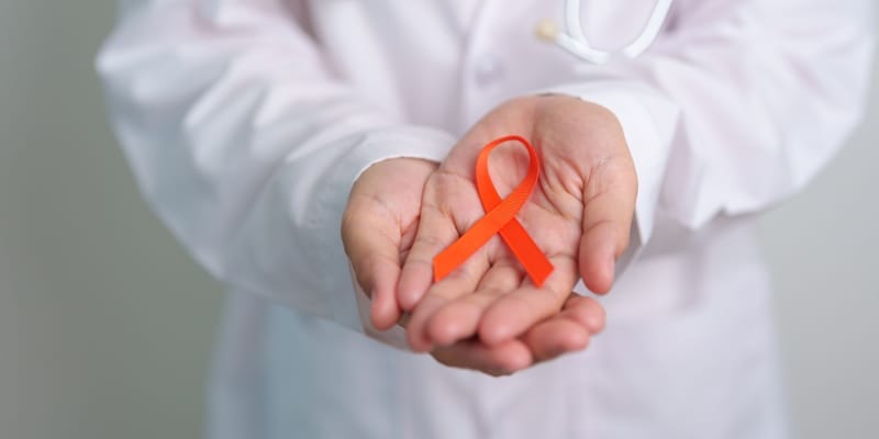 Hands with blood sample in testube depicting september as national blood cancer awareness month.