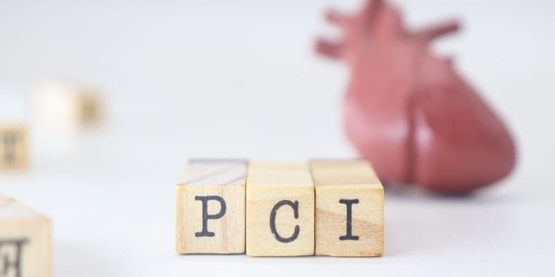 Wooden blocks arranged to represent a heart procedure, illustrating zero-contrast PCI techniques that protect both the kidneys and the heart.
